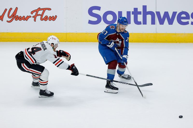 Oct 19, 2023; Denver, Colorado, USA; Colorado Avalanche left wing Jonathan Drouin (27) passes the puck as Chicago Blackhawks left wing Boris Katchouk (14) defends in the third period at Ball Arena. Mandatory Credit: Isaiah J. Downing-USA TODAY Sports