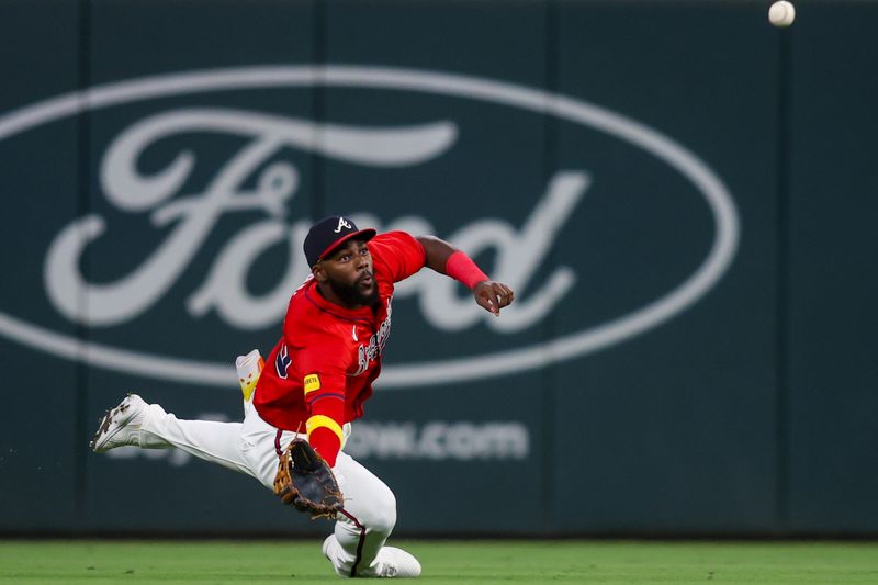 Sep 12, 2025; Atlanta, Georgia, USA; Atlanta Braves center fielder Michael Harris II (23) dives for a ball against the Houston Astros in the fifth inning at Truist Park. Mandatory Credit: Brett Davis-Imagn Images