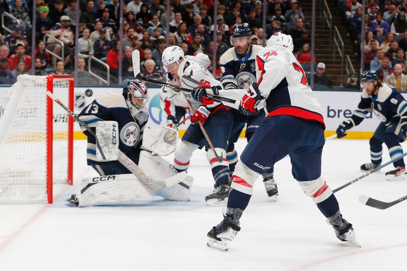 Oct 24, 2025; Columbus, Ohio, USA; Columbus Blue Jackets goalie Jet Greaves (73) shoulders away the shot from Washington Capitals defenseman John Carlson (74) during the first period at Nationwide Arena. Mandatory Credit: Russell LaBounty-Imagn Images