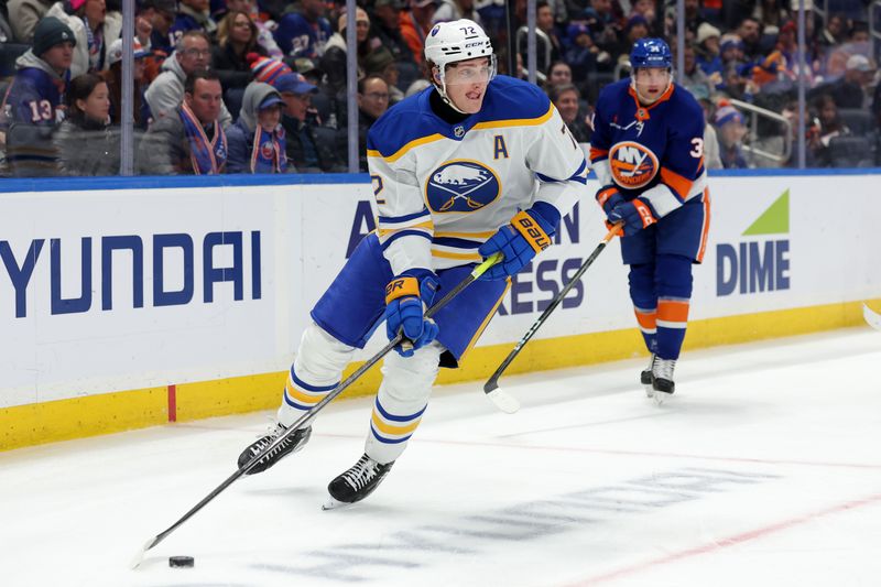 Nov 30, 2024; Elmont, New York, USA; Buffalo Sabres center Tage Thompson (72) skates with the puck against New York Islanders defenseman Grant Hutton (34) during the third period at UBS Arena. Mandatory Credit: Brad Penner-Imagn Images