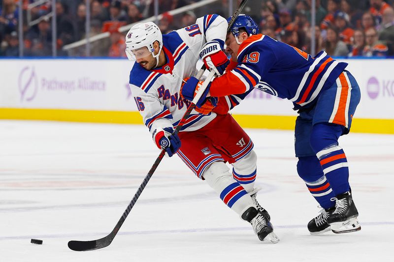 Nov 23, 2024; Edmonton, Alberta, CAN; Edmonton Oilers defensemen Ty Emberson (49) knocks New York Rangers forward Vincent Trocheck (16) off the puck during the second period  at Rogers Place. Mandatory Credit: Perry Nelson-Imagn Images