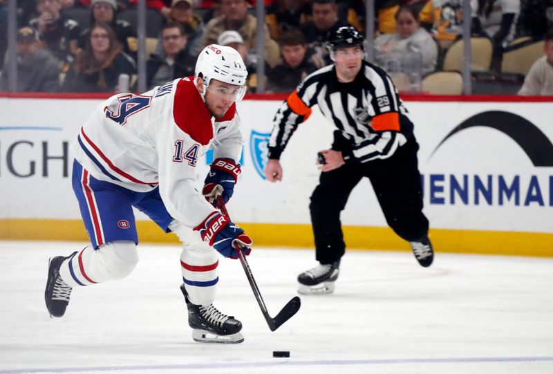 Feb 22, 2024; Pittsburgh, Pennsylvania, USA; Montreal Canadiens center Nick Suzuki (14) skates up ice with the puck against the Pittsburgh Penguins during the second period at PPG Paints Arena. Mandatory Credit: Charles LeClaire-USA TODAY Sports