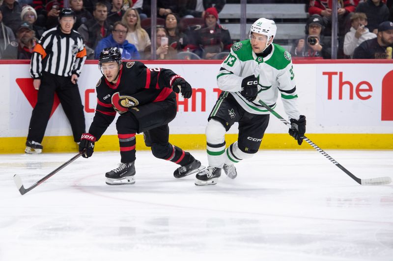 Feb 22, 2024; Ottawa, Ontario, CAN; Ottawa Senators defenseman Erik Brannstrom (26) moves the puck with Dallas Stars defenseman Derrick Pouliot (33) closing in during the first period at the Canadian Tire Centre. Mandatory Credit: Marc DesRosiers-USA TODAY Sports