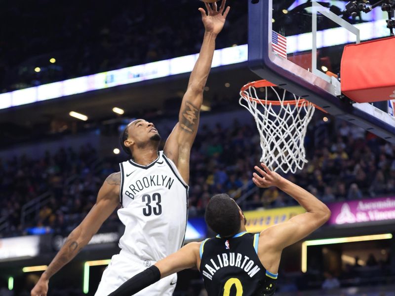 INDIANAPOLIS, INDIANA - MARCH 16: Nic Claxton #33 of the Brooklyn Nets blocks the shot of Tyrese Haliburton #0 of the Indiana Pacers during the second half at Gainbridge Fieldhouse on March 16, 2024 in Indianapolis, Indiana. NOTE TO USER: User expressly acknowledges and agrees that, by downloading and or using this photograph, User is consenting to the terms and conditions of the Getty Images License Agreement. (Photo by Justin Casterline/Getty Images)