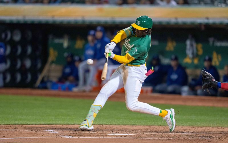 Sep 24, 2024; Oakland, California, USA; Oakland Athletics right fielder Lawrence Butler (4) hits a double against the Texas Rangers during the third inning at Oakland-Alameda County Coliseum. Mandatory Credit: Neville E. Guard-Imagn Images