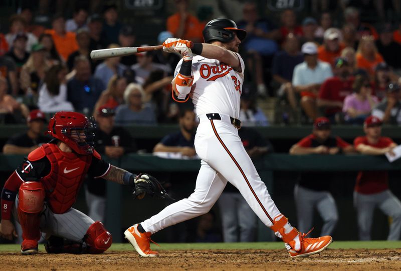 Mar 14, 2025; Sarasota, Florida, USA; Baltimore Orioles first base Ryan O'Hearn (32) doubles during the fifth inning against the Minnesota Twins  at Ed Smith Stadium. Mandatory Credit: Kim Klement Neitzel-Imagn Images