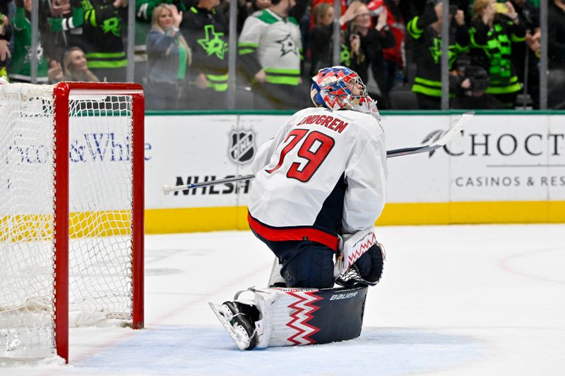 Jan 27, 2024; Dallas, Texas, USA; Washington Capitals goaltender Charlie Lindgren (79) watches the replay screen after he allows the game winning goal to Dallas Stars defenseman Thomas Harley (55) during the overtime period as the Stars defeat the Capitals at the American Airlines Center. Mandatory Credit: Jerome Miron-USA TODAY Sports