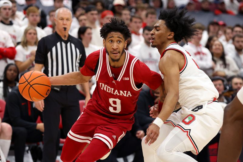 Jan 17, 2025; Columbus, Ohio, USA; Indiana Hoosiers guard Kanaan Carlyle (9) dribbles the ball as Ohio State Buckeyes guard Ques Glover (6) defends during the first half at Value City Arena. Mandatory Credit: Joseph Maiorana-Imagn Images