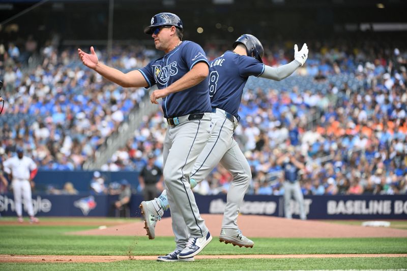 Jul 25, 2024; Toronto, Ontario, CAN; Tampa Bay Rays designated hitter Brandon Lowe (8) celebrates with third base coach Brady Williams (4) after hitting a solo home run against the Toronto Blue Jays in the first inning at Rogers Centre. Mandatory Credit: Dan Hamilton-USA TODAY Sports