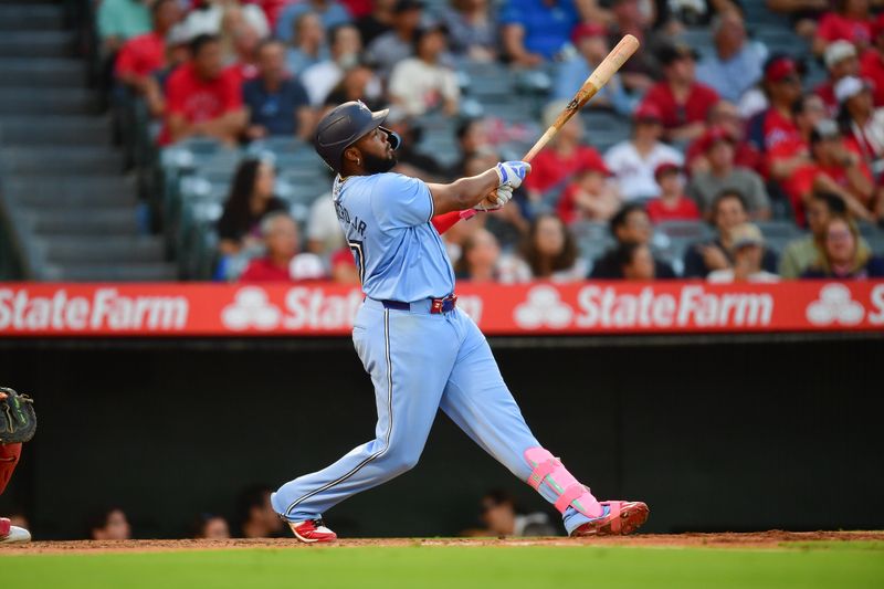 Aug 13, 2024; Anaheim, California, USA; Toronto Blue Jays first baseman Vladimir Guerrero Jr. (27) hits a solo home run against the Los Angeles Angels during the third inning at Angel Stadium. Mandatory Credit: Gary A. Vasquez-USA TODAY Sports