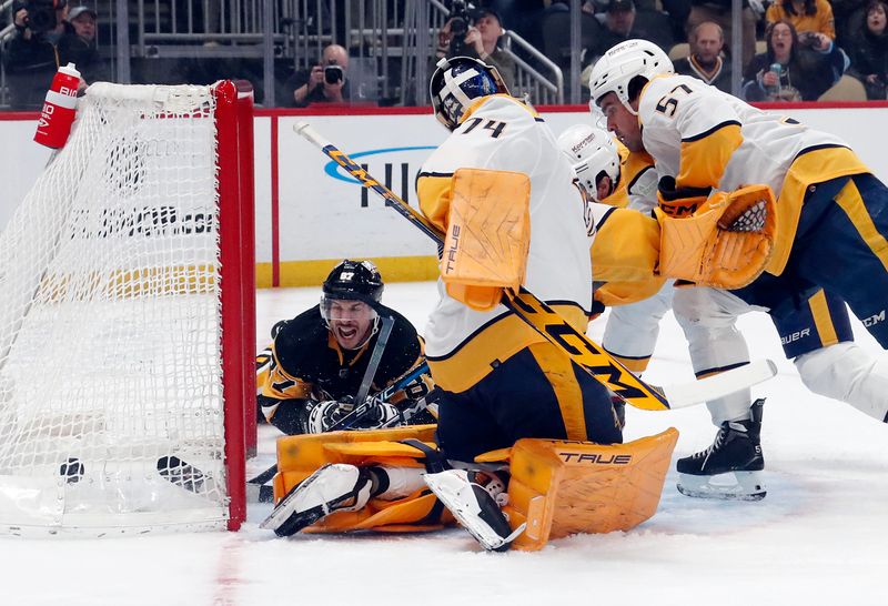 Apr 15, 2024; Pittsburgh, Pennsylvania, USA;  Pittsburgh Penguins center Sidney Crosby (87) scores a goal against Nashville Predators goaltender Juuse Saros (74) during the first period at PPG Paints Arena. Mandatory Credit: Charles LeClaire-USA TODAY Sports