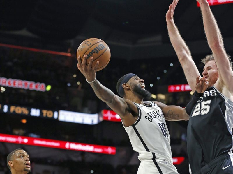 SAN ANTONIO, TX - JANUARY 17:  Royce ONeale #00 of the Brooklyn Nets drives over Jakob Poeltl #25 of the San Antonio Spurs in the first half at AT&T Center on January 17, 2023 in San Antonio, Texas. NOTE TO USER: User expressly acknowledges and agrees that, by downloading and or using this photograph, User is consenting to terms and conditions of the Getty Images License Agreement. (Photo by Ronald Cortes/Getty Images)