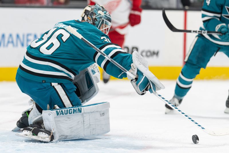 Jan 2, 2024; San Jose, California, USA; San Jose Sharks goaltender Kaapo Kahkonen (36) attempts to stop the puck  during the first period against the Detroit Red Wings at SAP Center at San Jose. Mandatory Credit: Stan Szeto-USA TODAY Sports