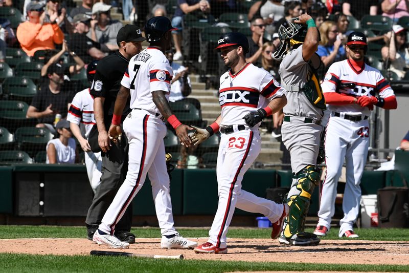 Aug 27, 2023; Chicago, Illinois, USA;  Chicago White Sox shortstop Tim Anderson (7) and Chicago White Sox left fielder Andrew Benintendi (23) high five after scoring against the Oakland Athletics seventh inning at Guaranteed Rate Field. Mandatory Credit: Matt Marton-USA TODAY Sports