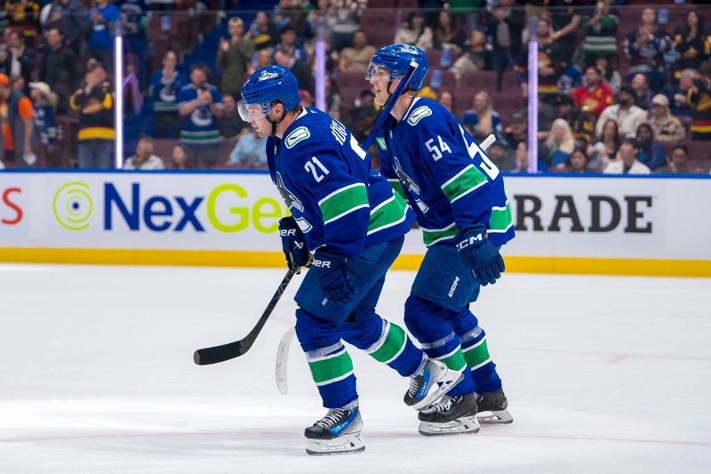 Sep 24, 2024; Vancouver, British Columbia, CAN;  Vancouver Canucks forward Aatu Raty (54) and forward Nils Hoglander (21) celebrate Hoglander’s goal against the Seattle Kraken during the first period at Rogers Arena. Mandatory Credit: Bob Frid-Imagn Images