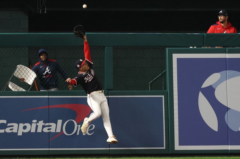 Sep 16, 2025; Washington, District of Columbia, USA; Washington Nationals outfielder Daylen Lile (51) attempts to catch a double hit by Atlanta Braves outfielder Michael Harris II (not pictured) during the seventh inning at Nationals Park. Mandatory Credit: Geoff Burke-Imagn Images