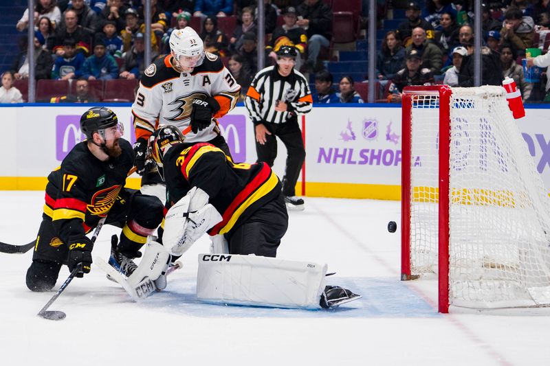 Nov 28, 2023; Vancouver, British Columbia, CAN; Vancouver Canucks defenseman Filip Hronek (17) and Anaheim Ducks forward Jakob Silfverberg (33) watch the puck hit the goal post behind goalie Thatcher Demko (35)  in the third period at Rogers Arena. Vancouver won 3-1. Mandatory Credit: Bob Frid-USA TODAY Sports