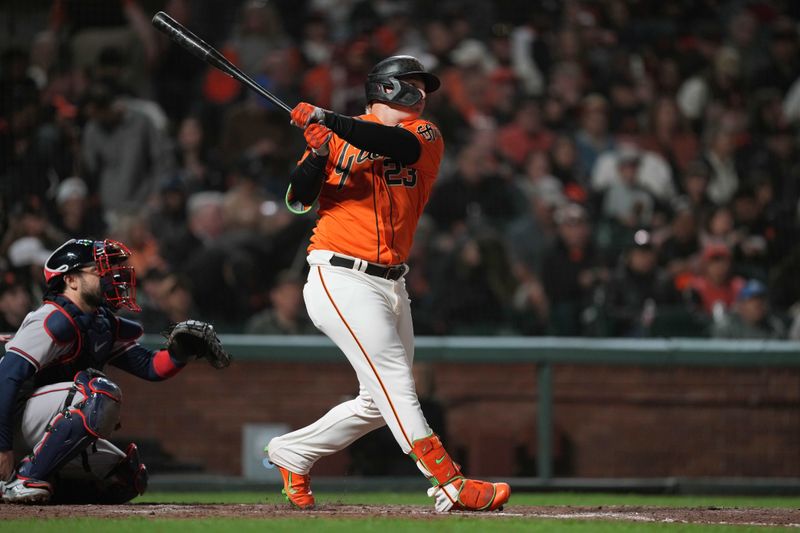 Aug 25, 2023; San Francisco, California, USA; San Francisco Giants left fielder Joc Pederson (23) hits a triple against the Atlanta Braves during the seventh inning at Oracle Park. Mandatory Credit: Darren Yamashita-USA TODAY Sports