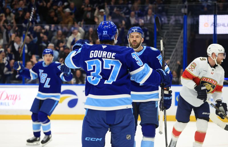 Feb 5, 2026; Tampa, Florida, USA; Tampa Bay Lightning center Zemgus Girgensons (28) is congratulated by center Yanni Gourde (37) after scoring against the Florida Panthers during the first period at Benchmark International Arena. Mandatory Credit: Kim Klement Neitzel-Imagn Images
