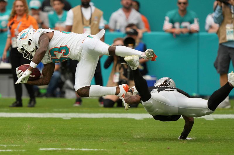 Las Vegas Raiders wide receiver DJ Turner (19) tackles Miami Dolphins wide receiver Malik Washington (83) on a punt return during the second half of an NFL football game, Sunday, Nov. 17, 2024, in Miami Gardens, Fla. (AP Photo/Lynne Sladky)