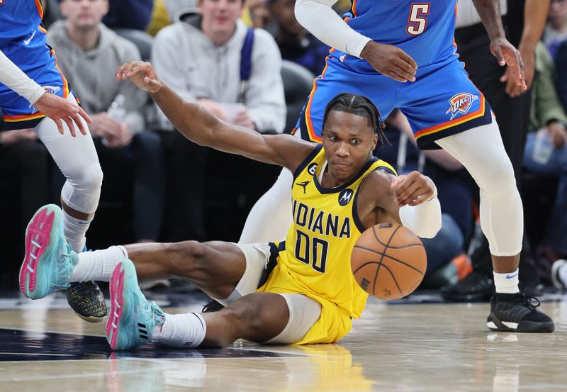 INDIANAPOLIS, INDIANA - MARCH 31:  Bennedict Mathurin #00 of the Indiana Pacers reaches for a loose ball against the Oklahoma City Thunder at Gainbridge Fieldhouse on March 31, 2023 in Indianapolis, Indiana.    NOTE TO USER: User expressly acknowledges and agrees that, by downloading and/or using this photograph, User is consenting to the terms and conditions of the Getty Images License Agreement. (Photo by Andy Lyons/Getty Images)