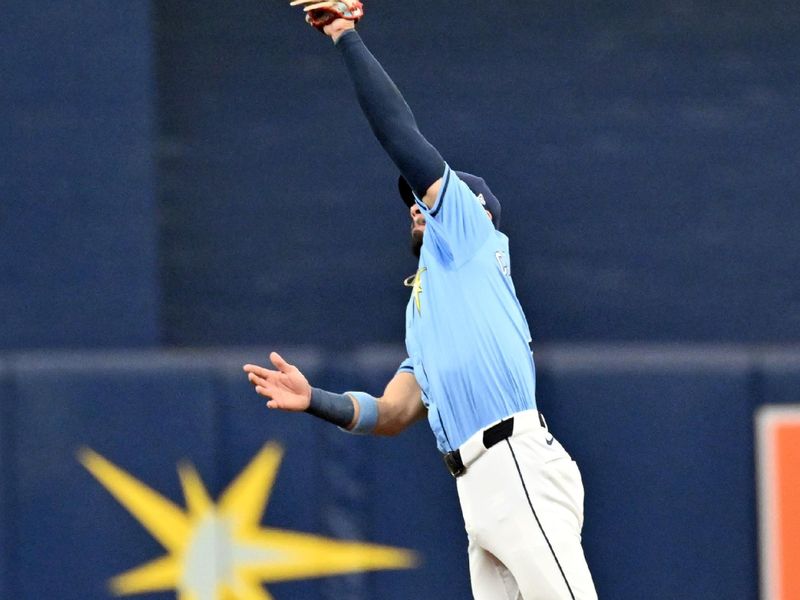 Sep 22, 2024; St. Petersburg, Florida, USA; Tampa Bay Rays second baseman Jose Caballero (7) catches a line drive in the second inning against the Toronto Blue Jays at Tropicana Field. Mandatory Credit: Jonathan Dyer-Imagn Images