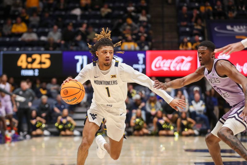 Jan 9, 2024; Morgantown, West Virginia, USA; West Virginia Mountaineers guard Noah Farrakhan (1) drives against Kansas State Wildcats guard Cam Carter (5) during the second half at WVU Coliseum. Mandatory Credit: Ben Queen-USA TODAY Sports