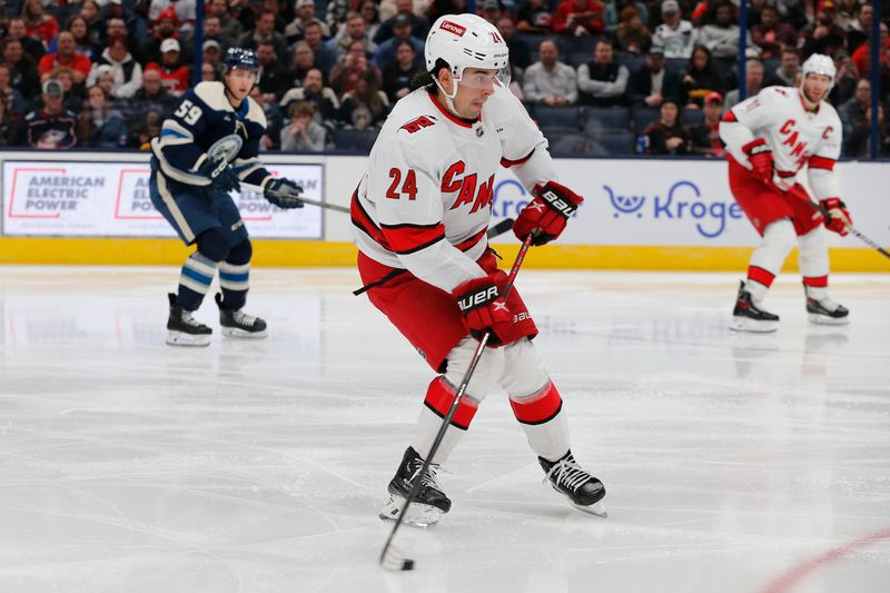 Feb 29, 2024; Columbus, Ohio, USA; Carolina Hurricanes center Seth Jarvis (24) looks to pass against the Columbus Blue Jackets during the second period at Nationwide Arena. Mandatory Credit: Russell LaBounty-USA TODAY Sports