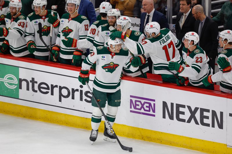 Feb 7, 2024; Chicago, Illinois, USA; Minnesota Wild center Jacob Lucchini (27) celebrates with teammates after scoring against the Chicago Blackhawks during the first period at United Center. Mandatory Credit: Kamil Krzaczynski-USA TODAY Sports