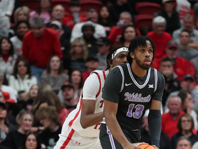 Jan 13, 2024; Lubbock, Texas, USA;  Kansas State Wildcats center Will McNair Jr. (13) passes the ball in front of Texas Tech Red Raiders forward Warren Washington (22) in the first half at United Supermarkets Arena. Mandatory Credit: Michael C. Johnson-USA TODAY Sports