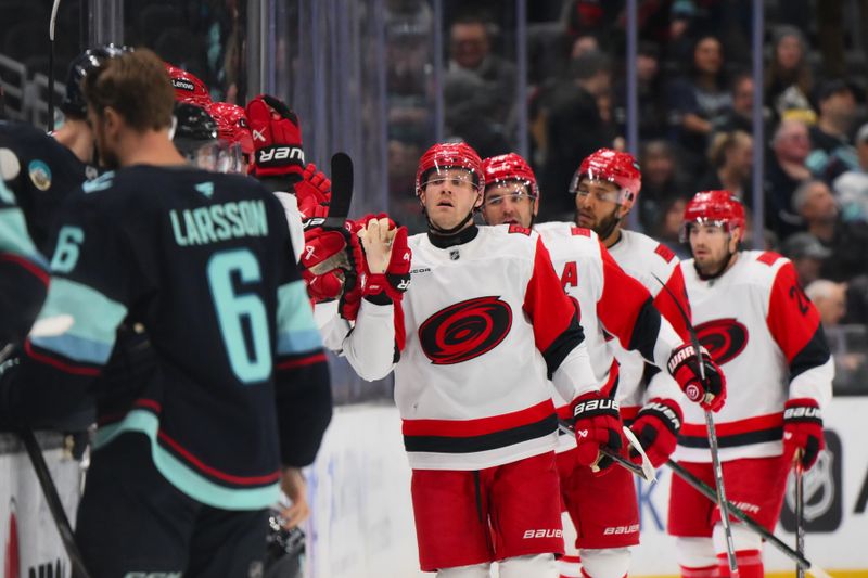 Mar 2, 2026; Seattle, Washington, USA; Carolina Hurricanes left wing Nikolaj Ehlers (27) celebrates with the bench after scoring a goal against the Seattle Kraken during the second period at Climate Pledge Arena. Mandatory Credit: Steven Bisig-Imagn Images
