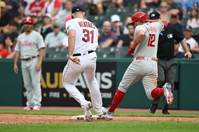 Jul 23, 2023; Cleveland, Ohio, USA; Philadelphia Phillies left fielder Kyle Schwarber (12) beats Cleveland Guardians relief pitcher Sam Hentges (31) to the base for an RBI single during the fifth inning at Progressive Field. Mandatory Credit: Ken Blaze-USA TODAY Sports