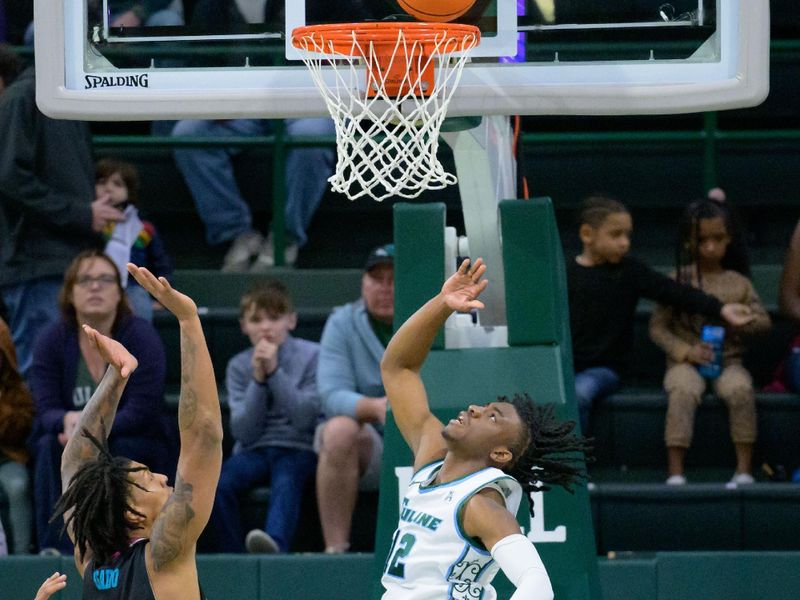 Jan 11, 2024; New Orleans, Louisiana, USA;  Tulane Green Wave guard Kolby King (12) shoots against Florida Atlantic Owls forward Giancarlo Rosado (3) during the first half at Avron B. Fogelman Arena in Devlin Fieldhouse. Mandatory Credit: Matthew Hinton-USA TODAY Sports