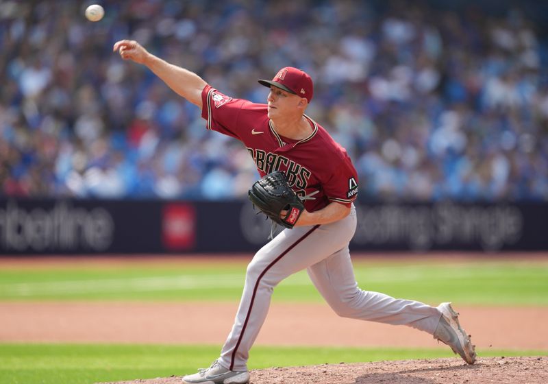 Jul 16, 2023; Toronto, Ontario, CAN; Arizona Diamondbacks relief pitcher Scott McGough (30) throws a pitch against the Toronto Blue Jays during the eighth inning at Rogers Centre. Mandatory Credit: Nick Turchiaro-USA TODAY Sports