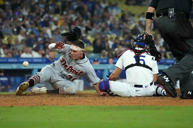 Sep 20, 2023; Los Angeles, California, USA; Detroit Tigers right fielder Kerry Carpenter (30) slides into home plate to beat a throw to Los Angeles Dodgers catcher Austin Barnes (15) to score in the eighth inning at Dodger Stadium. Mandatory Credit: Kirby Lee-USA TODAY Sports