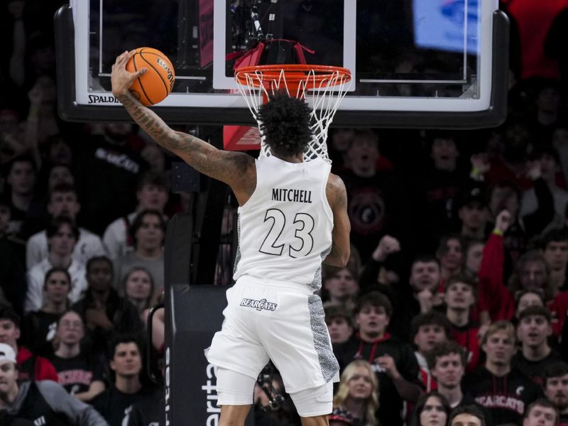 Jan 18, 2025; Cincinnati, Ohio, USA;  Cincinnati Bearcats forward Dillon Mitchell (23) dunks the ball against the Arizona State Sun Devils in the second half at Fifth Third Arena. Mandatory Credit: Aaron Doster-Imagn Images