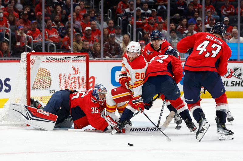 Oct 16, 2023; Washington, District of Columbia, USA; Calgary Flames center Blake Coleman (20) and Washington Capitals defenseman Martin Fehervary (42) battle for the puck infant of Capitals goaltender Darcy Kuemper (35) in the second period at Capital One Arena. Mandatory Credit: Geoff Burke-USA TODAY Sports