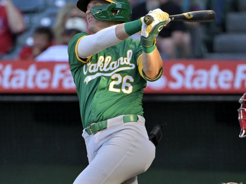 Jun 24, 2024; Anaheim, California, USA;  Oakland Athletics right fielder Tyler Nevin (26) hits a solo home run in the second inning against the Los Angeles Angels at Angel Stadium. Mandatory Credit: Jayne Kamin-Oncea-USA TODAY Sports