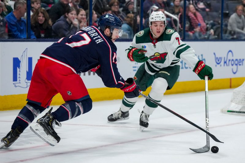 Jan 6, 2024; Columbus, Ohio, USA;  Columbus Blue Jackets right wing Justin Danforth (17) skates for the puck against Minnesota Wild defenseman Brock Faber (7) in the first period at Nationwide Arena. Mandatory Credit: Aaron Doster-USA TODAY Sports