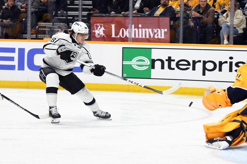 Jan 31, 2024; Nashville, Tennessee, USA; Los Angeles Kings left winger Alex Turcotte (38) scores against Nashville Predators goaltender Juuse Saros (74) during the second period at Bridgestone Arena. Mandatory Credit: Christopher Hanewinckel-USA TODAY Sports