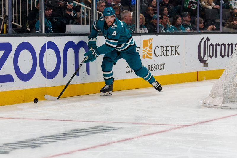 Jan 18, 2023; San Jose, California, USA;  San Jose Sharks defenseman Scott Harrington (4) controls the puck during the third period against the Dallas Stars at SAP Center at San Jose. Mandatory Credit: Neville E. Guard-USA TODAY Sports