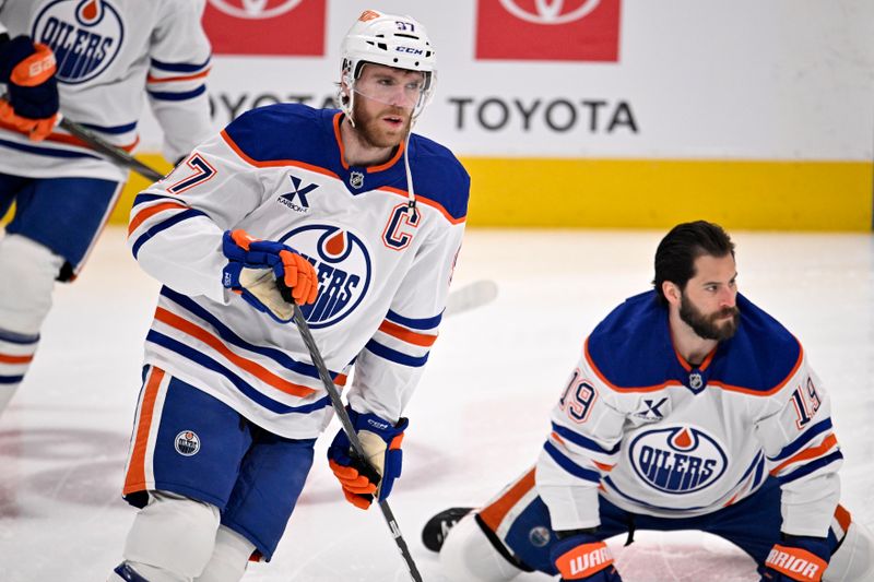 May 21, 2025; Dallas, Texas, USA; Edmonton Oilers center Connor McDavid (97) and center Adam Henrique (19) practice before game one of the Western Conference Final of the 2025 Stanley Cup Playoffs at American Airlines Center. Mandatory Credit: Jerome Miron-Imagn Images