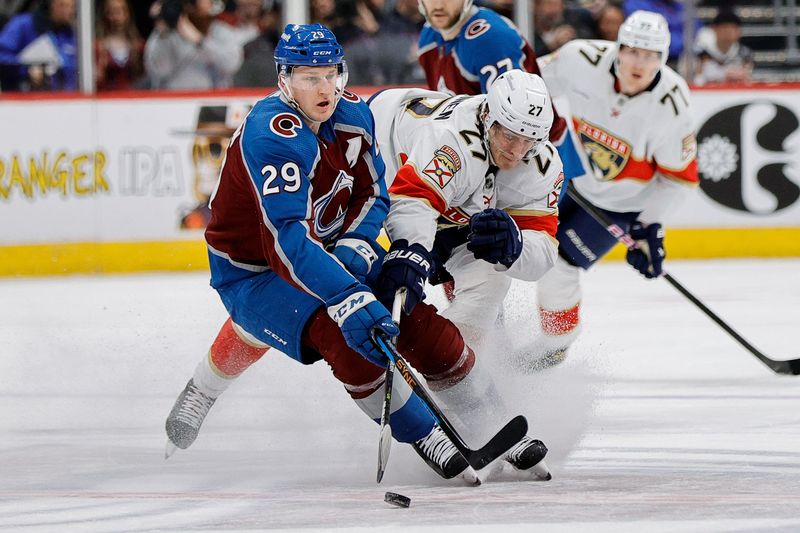 Jan 6, 2024; Denver, Colorado, USA; Colorado Avalanche center Nathan MacKinnon (29) and Florida Panthers center Eetu Luostarinen (27) battle for the puck in the first period at Ball Arena. Mandatory Credit: Isaiah J. Downing-USA TODAY Sports