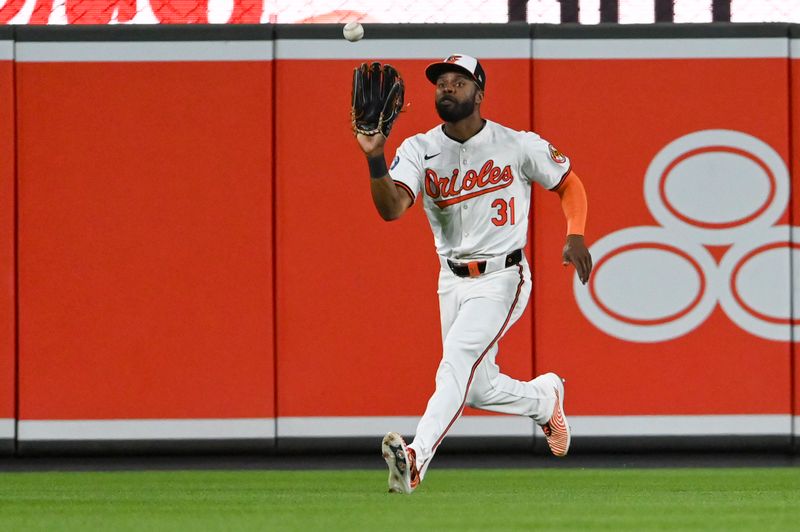 Jun 11, 2024; Baltimore, Maryland, USA; Baltimore Orioles outfielder Cedric Mullins (31) runs down a ninth inning fly ball against the Atlanta Braves  at Oriole Park at Camden Yards. Mandatory Credit: Tommy Gilligan-USA TODAY Sports