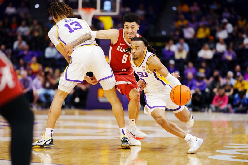 Feb 4, 2023; Baton Rouge, Louisiana, USA; LSU Tigers guard Justice Hill (3) drives to the basket against Alabama Crimson Tide guard Jahvon Quinerly (5) during the first half at Pete Maravich Assembly Center. Mandatory Credit: Andrew Wevers-USA TODAY Sports