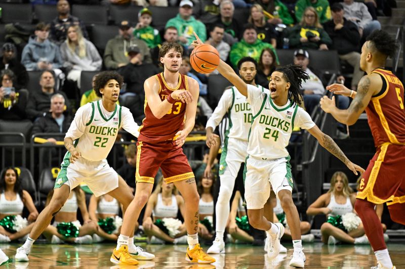 Dec 2, 2025; Eugene, Oregon, USA; Oregon Ducks guard Jamari Phillips (24) defends a pass from Southern California Trojans forward Jaden Brownell (33) to forward Terrance Williams II (5) during the first half at Matthew Knight Arena. Mandatory Credit: Craig Strobeck-Imagn Images