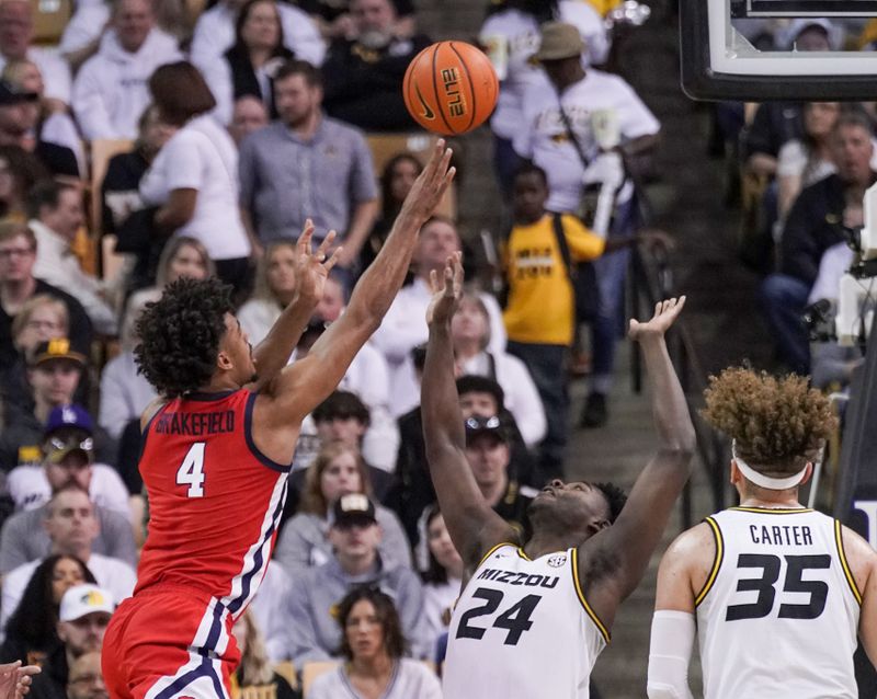 Mar 4, 2023; Columbia, Missouri, USA; Mississippi Rebels forward Jaemyn Brakefield (4) shoots as Missouri Tigers guard Kobe Brown (24) defends during the first half at Mizzou Arena. Mandatory Credit: Denny Medley-USA TODAY Sports