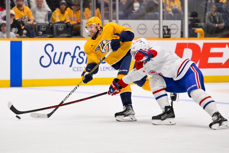 Mar 28, 2026; Nashville, Tennessee, USA;   Montreal Canadiens defenseman Kaiden Guhle (21) blocks the shot of Nashville Predators center Steven Stamkos (91) during the first period Gat Bridgestone Arena. Mandatory Credit: Steve Roberts-Imagn Images