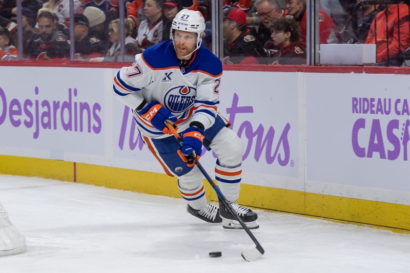 Nov 19, 2024; Ottawa, Ontario, CAN; Edmonton Oilers defenseman Brett Kulak (27) skates with the puck in hte first period against the  Ottawa Senators at the Canadian Tire Centre. Mandatory Credit: Marc DesRosiers-Imagn Images