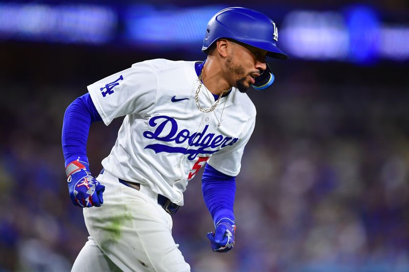 Apr 13, 2024; Los Angeles, California, USA; Los Angeles Dodgers shortstop Mookie Betts (50) runs after hitting a single against the San Diego Padres during the third inning at Dodger Stadium. Mandatory Credit: Gary A. Vasquez-USA TODAY Sports